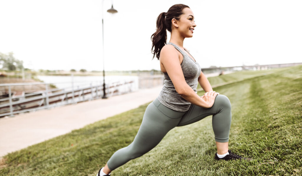 fitness woman stretching in the grass